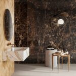 Et delikat bad i marmor som kombinerer marmorfliser, med små gule historiske fliser på vegg. Vask laget i marmorflis og gulvflis i betonglook.